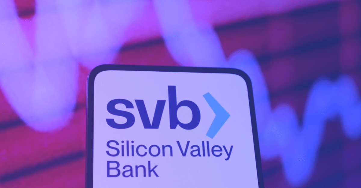 SVB Silicon Valley Bank logo on a phone screen in front a of a downward trending line graph